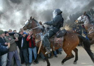 Mounted Israeli police scuffle with pro-settler supporters at the Amona outpost, February 1, 2006. (photo credit: REUTERS) 