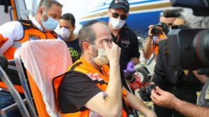 Eli Beer, founder and president of United Hatzalah, saying the Shema upon arriving in Israel after battling COVID-19 for six weeks at a hospital in Miami, Fla. Credit: United Hatzalah. 