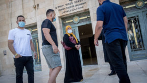 Amal Sumarin, her sons and their attorney arrives for a court hearing regarding the JNF-KKL appeal to evict them from their family home at the District Court in Jerusalem on June 30, 2020. Photo by Yonatan Sindel/Flash90.