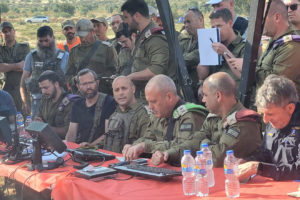 Binyamin Regional Council head Israel Ganz (in black T-shirt) and IDF Central Command Maj. Gen. Yehuda Fox (on Ganz's left) during the search for 14-year-old shepherd Binyamin Achimeir. Credit: Binyamin Regional Council Spokesperson.